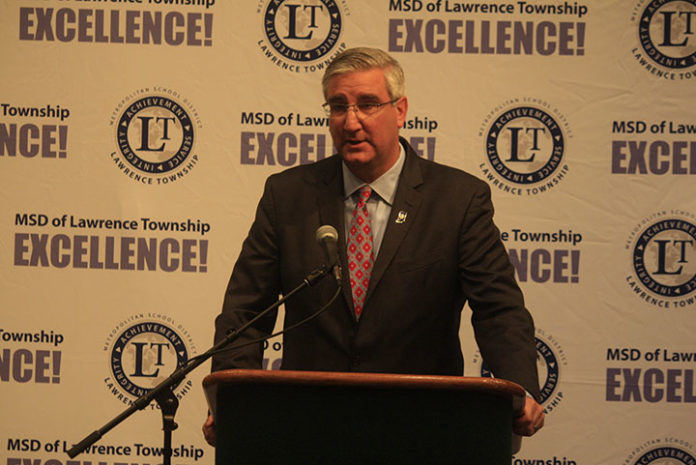 Eric Holcomb podium