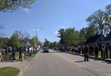 President Donald Trump’s supporters stand up to protesters while waiting in line