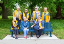 Lake City Lions install park bench on Heritage Trail ahead of White Cane Day