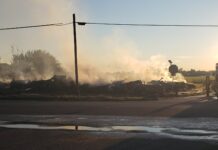Early morning fire destroys two barns south of Warsaw
