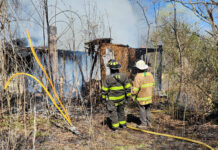 Grass fire spreads to vacant building in Palestine