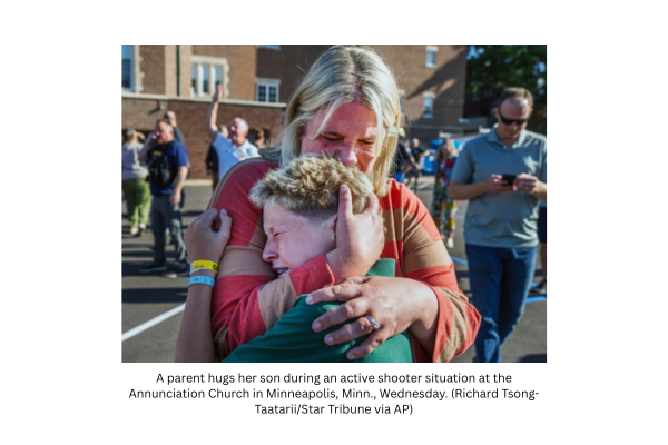 A parent hugs her son during an active shooter situation at the Annunciation Church in Minneapolis, Minn., Wednesday, Aug. 27, 2025. (Richard Tsong-TaatariiStar Tribune via AP)