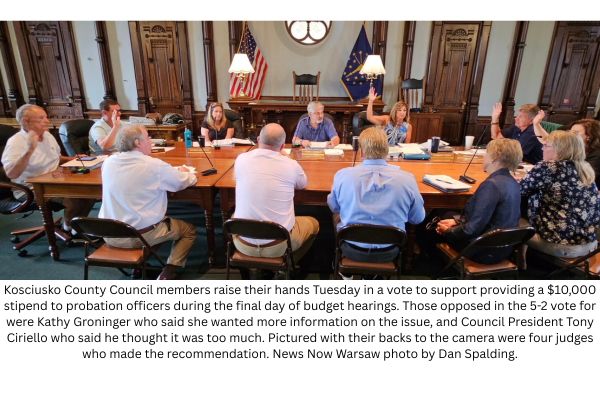 Kosciusko County Council members raise their hands Tuesday in a vote to support providing a $10,000 stipend for probation officers during the final day of budget hearings. Those opposed in the 5-2