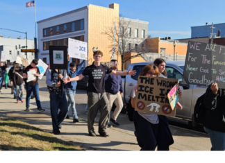 Counter-protester accused of assaulting adult woman at student protest in Warsaw High school protester walk along Center Street in Warsaw Friday afternoon after they walked out of class early in protest over the federal immigration crackdown. News Now Warsaw photo by Dan Spalding.